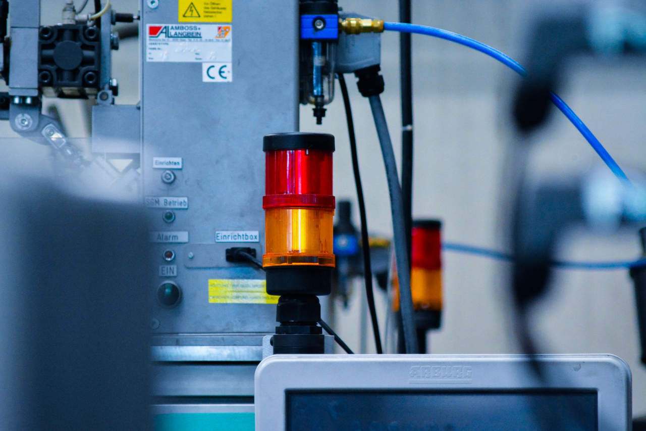 Detailed view of automated machinery with warning signals in an industrial setting.